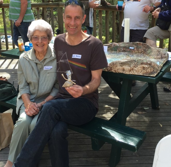Barbara and Green’s Senator, Nick McKim, 60th Anniversary of Lake Pedder National Park gathering; “Pull The Plug” model in the background.